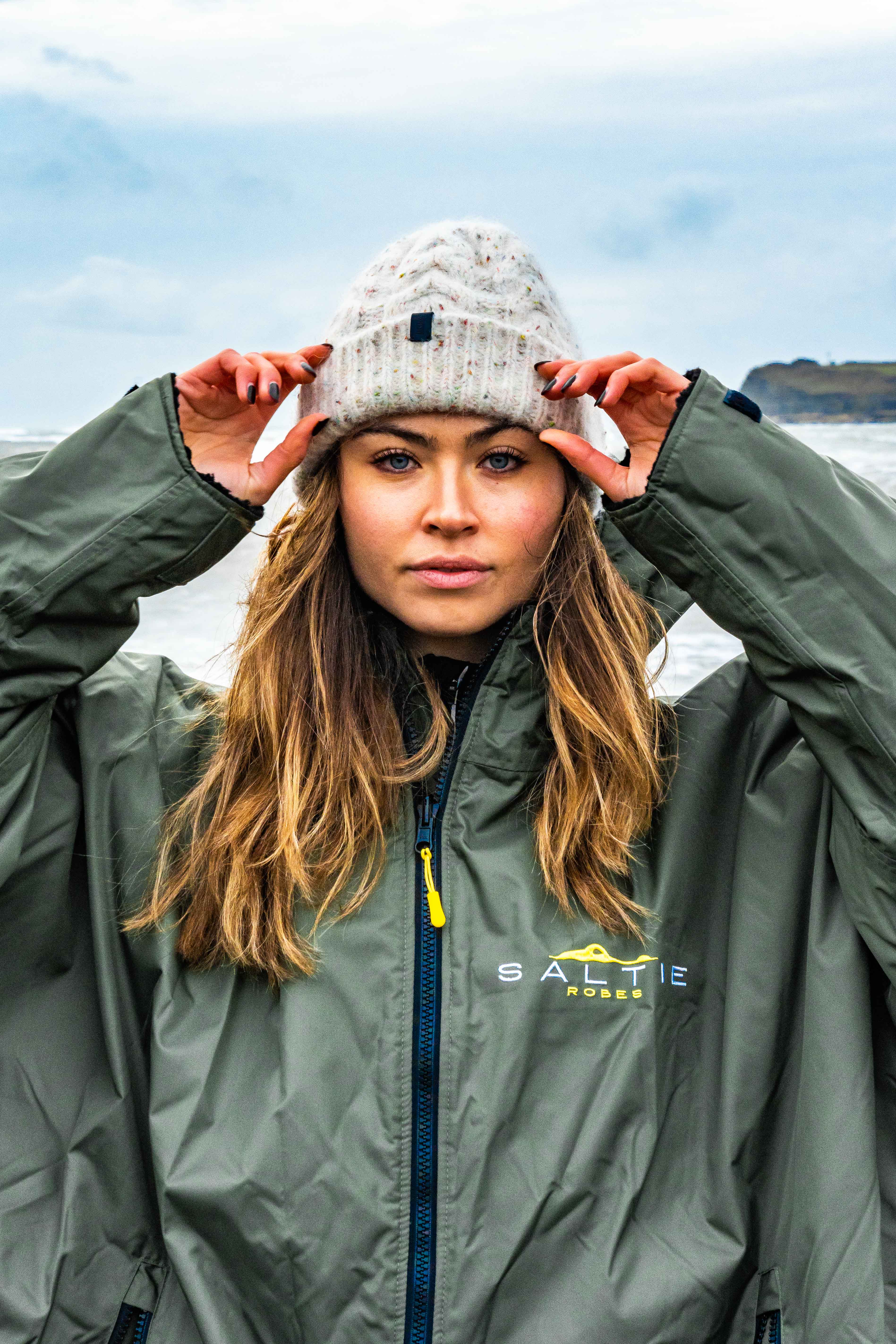 SALTIE Changing Robe in green, weather resistant, perfect for changing on the beach and made using 100% recycled materials. The SALTIE changing robe is designed keep you warm and dry during your sea swim, beach walks and all of your outdoor adventures.