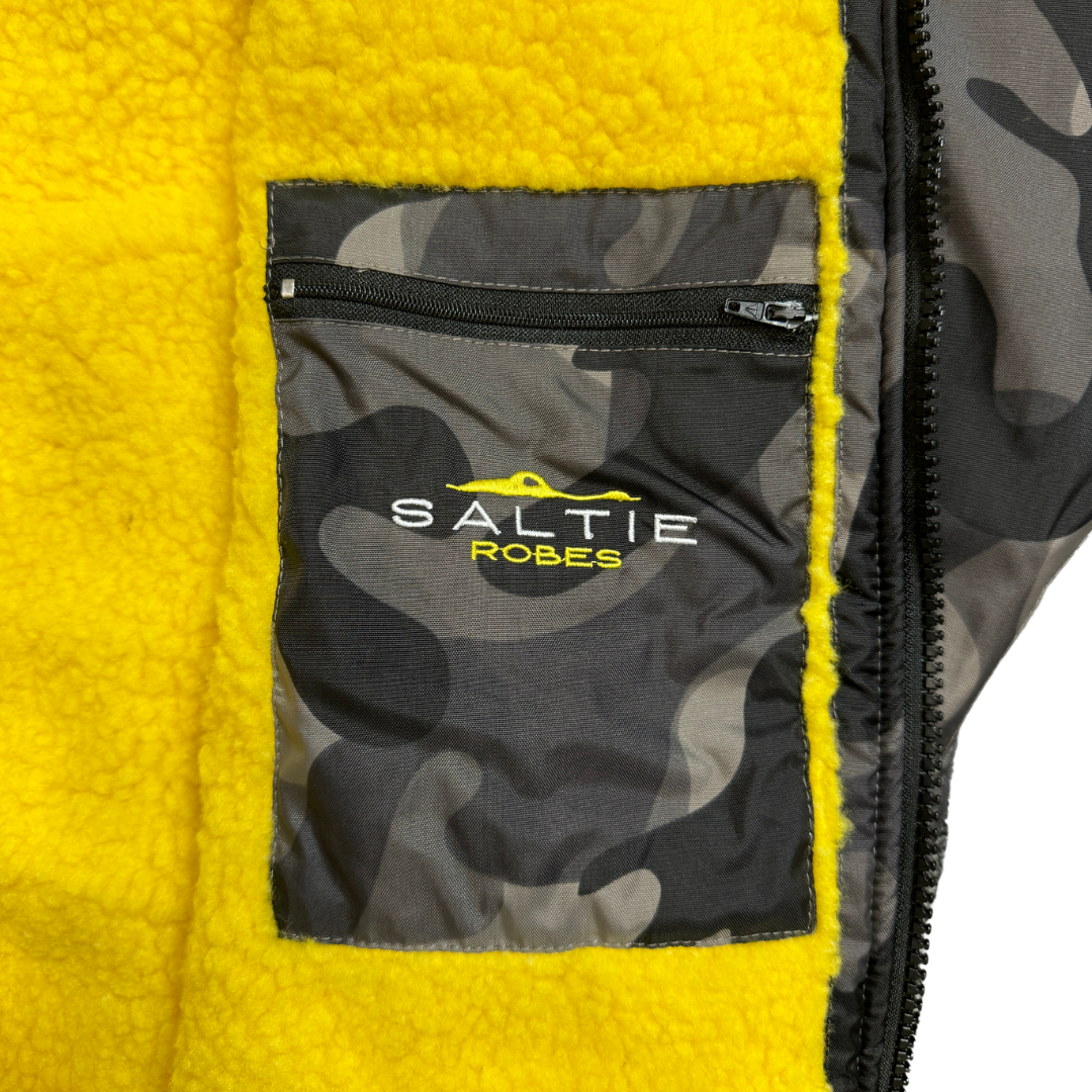 SALTIE Changing Robe in camo yellow, weather resistant, perfect for changing on the beach and made using 100% recycled materials. The SALTIE changing robe is designed keep you warm and dry during your sea swim, beach walks and all of your outdoor adventures.